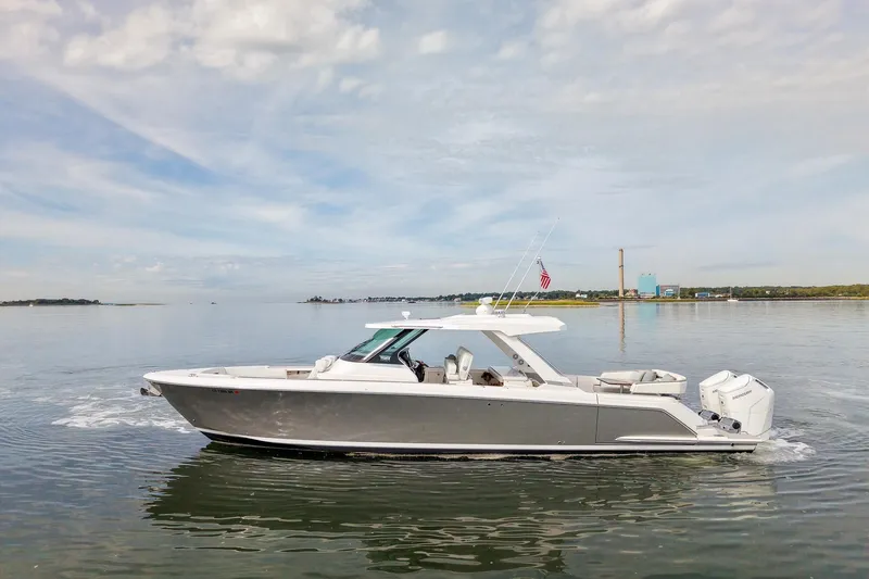 The Image of 2025 Tiara Yachts 43 LS cruising on calm waters under a cloudy sky. - 0