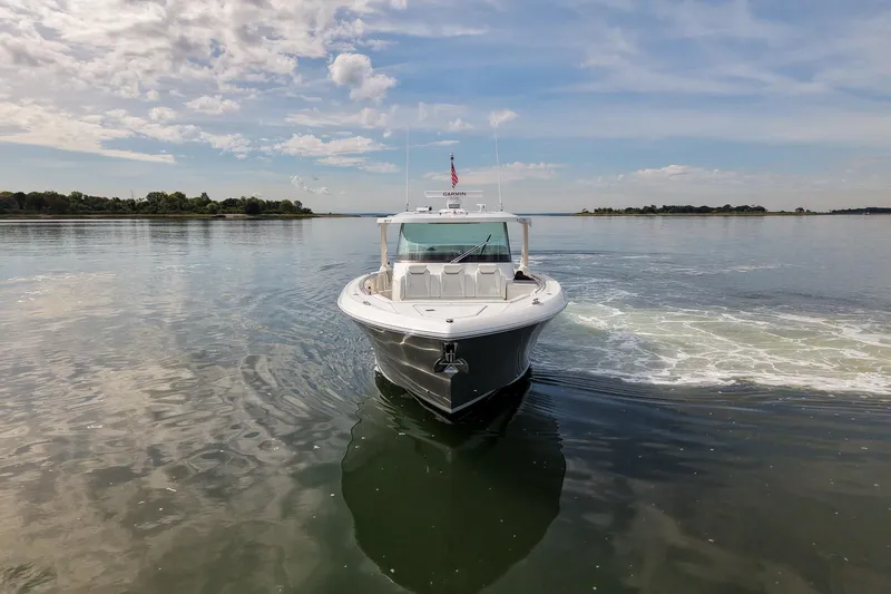 Slide: The Image of 2025 Tiara Yachts 43 LS cruising on calm waters under a partly cloudy sky. - 10