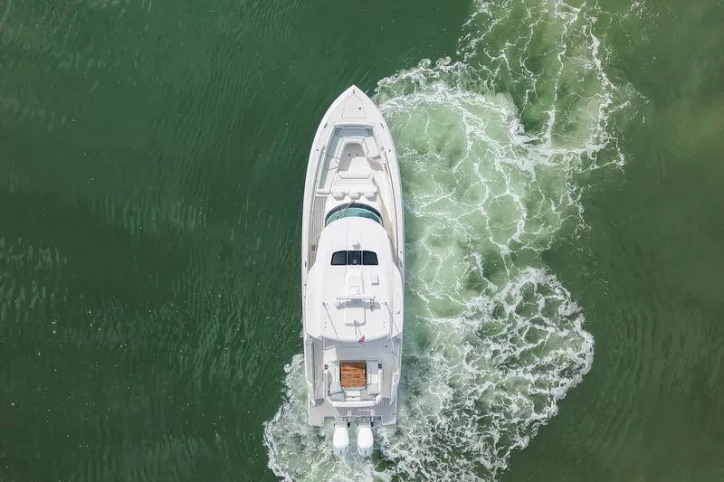 Slide: The Image of Aerial view of 2025 Tiara Yachts 43 LS cruising on green water. - 11