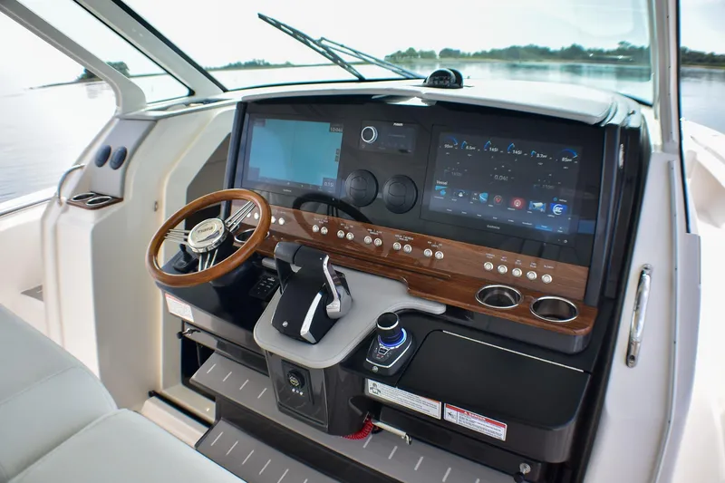 Slide: The Image of 2025 Tiara Yachts 43 LS helm with advanced navigation and control systems. - 13