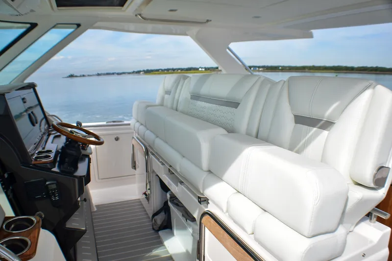 Slide: The Image of 2025 Tiara Yachts 43 LS interior with luxurious white seating and modern helm. - 15