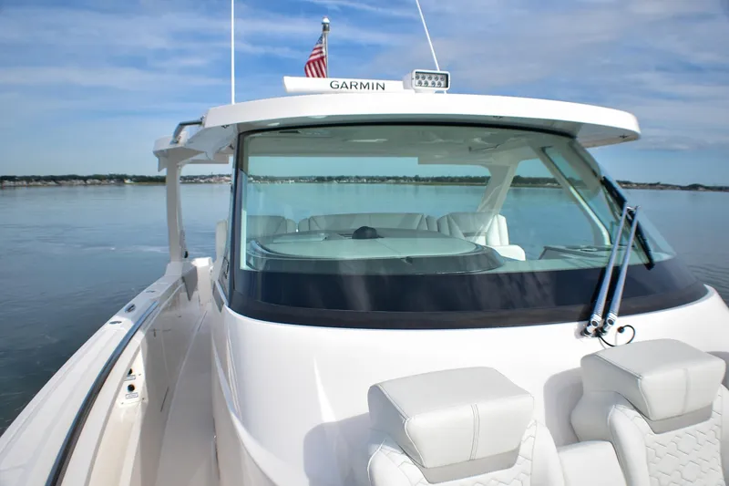 Slide: The Image of 2025 Tiara Yachts 43 LS on calm water, featuring sleek design and modern amenities. - 18