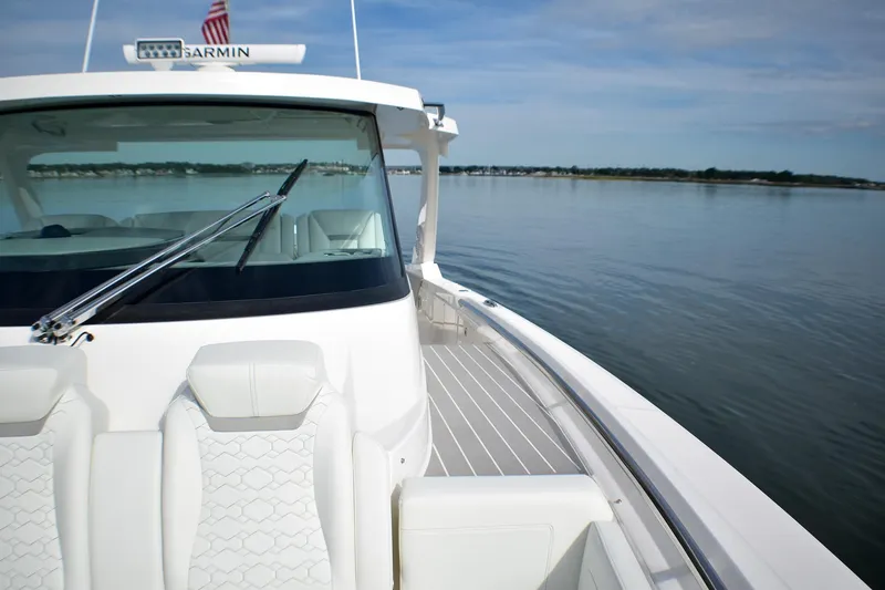 Slide: The Image of 2025 Tiara Yachts 43 LS on calm water, showcasing sleek design and luxury seating. - 19