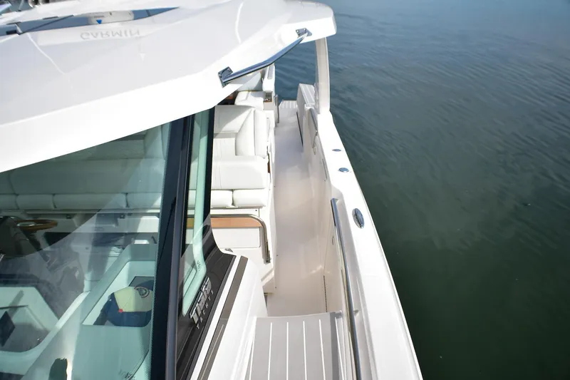 Slide: The Image of 2025 Tiara Yachts 43 LS luxury boat, sleek design, docked on calm water. - 20