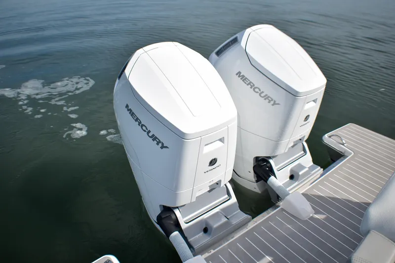 Slide: The Image of Twin Mercury outboard engines on a 2025 Tiara Yachts 43 LS, cruising on calm waters. - 24