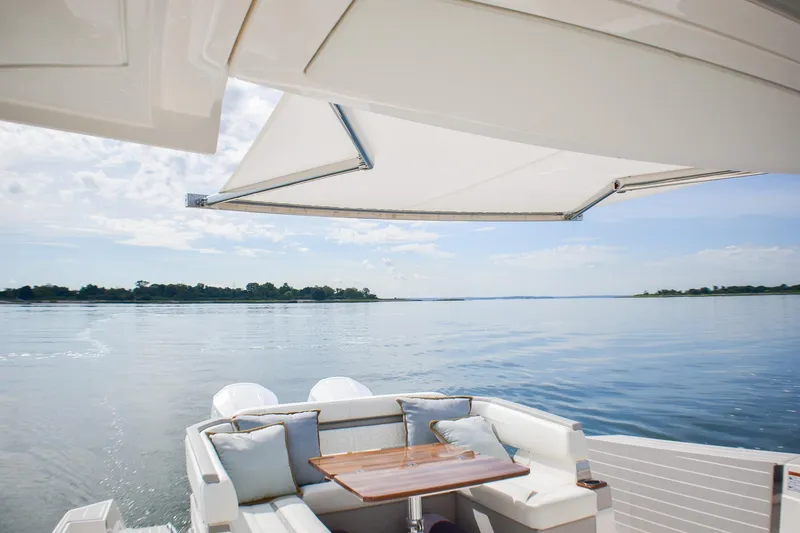 Slide: The Image of 2025 Tiara Yachts 43 LS with elegant seating and scenic water view. - 30