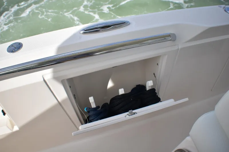 Slide: The Image of 2025 Tiara Yachts 43 LS storage compartment with ropes, open on deck. - 35