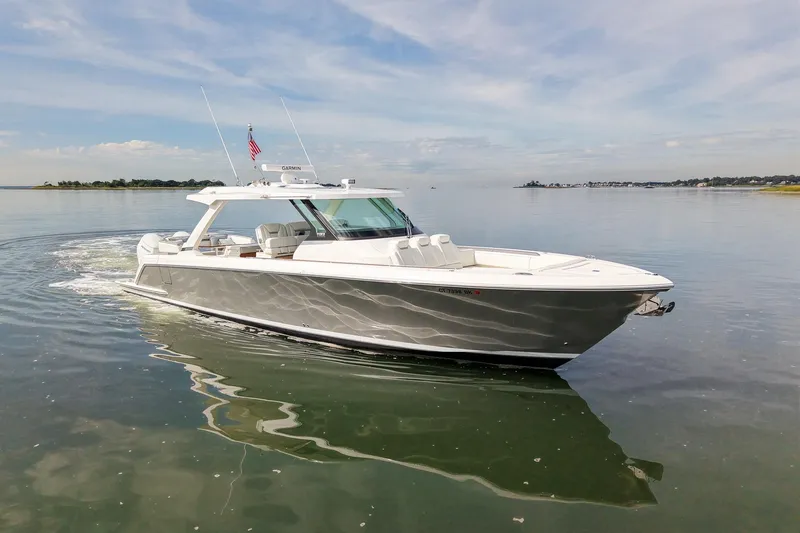 Slide: The Image of 2025 Tiara Yachts 43 LS cruising on calm waters under a clear sky. - 9