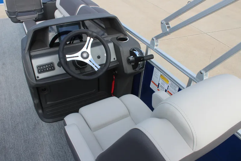 Slide: The Image of 2026 Sun Tracker Fishin' Barge 20 DLX helm with steering wheel and comfortable seating. - 14