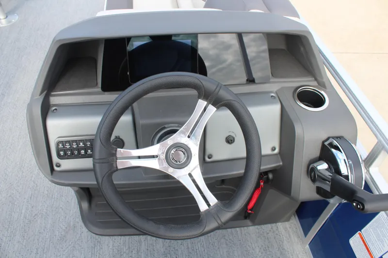 Slide: The Image of 2026 Sun Tracker Fishin' Barge 20 DLX steering console with modern controls and cup holder. - 15