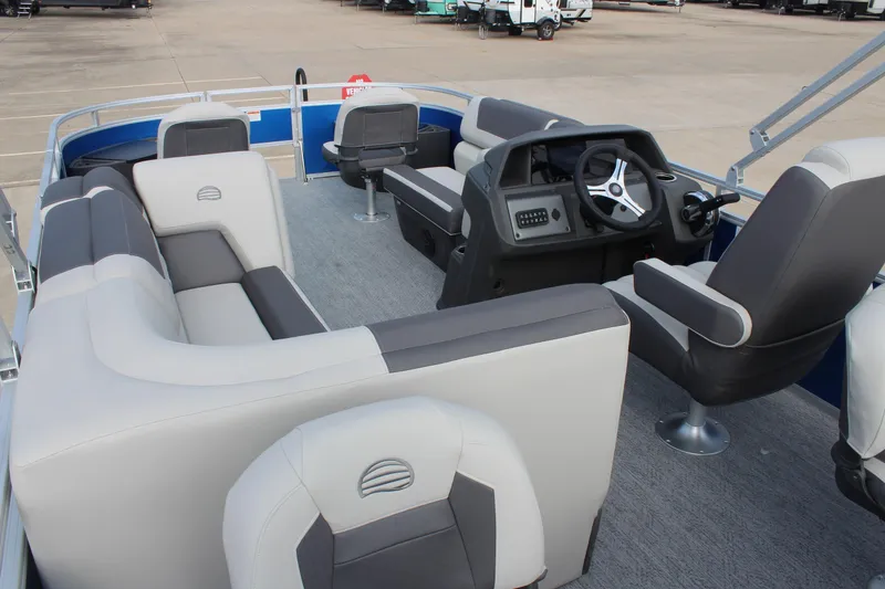 Slide: The Image of 2026 Sun Tracker Fishin' Barge 20 DLX interior with seating and steering console. - 19