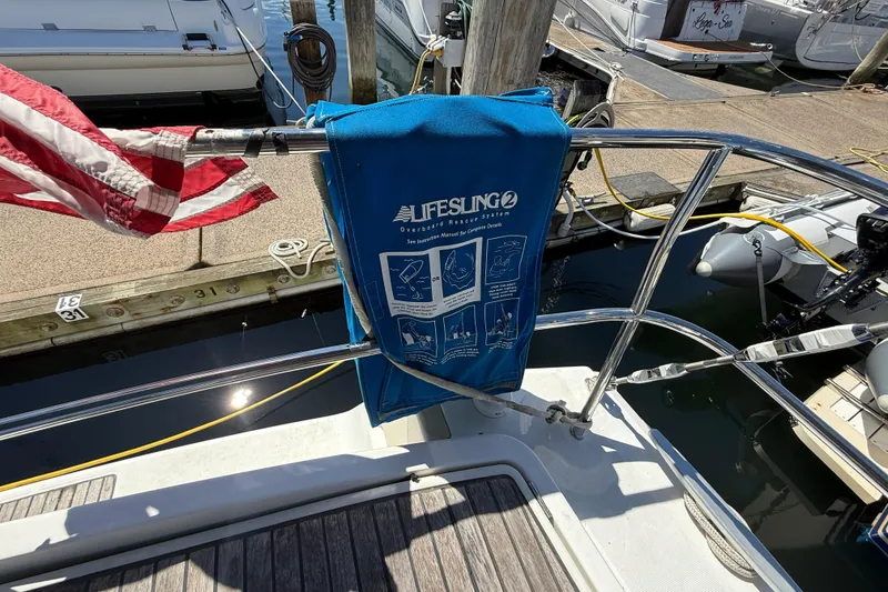 Slide: The Image of Beneteau Oceanis 43 sailboat with Lifesling rescue system and American flag at dock. - 20