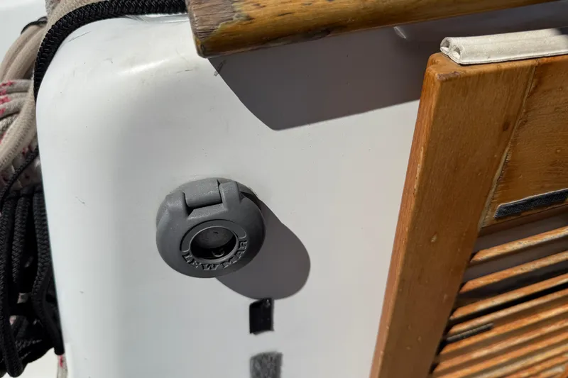Slide: The Image of Close-up of a 2010 Beneteau Oceanis 43 boat detail, featuring wood and a plug socket. - 25