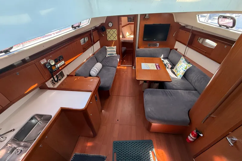 Slide: The Image of Interior of 2010 Beneteau Oceanis 43 yacht with cozy seating, kitchen, and TV. - 26