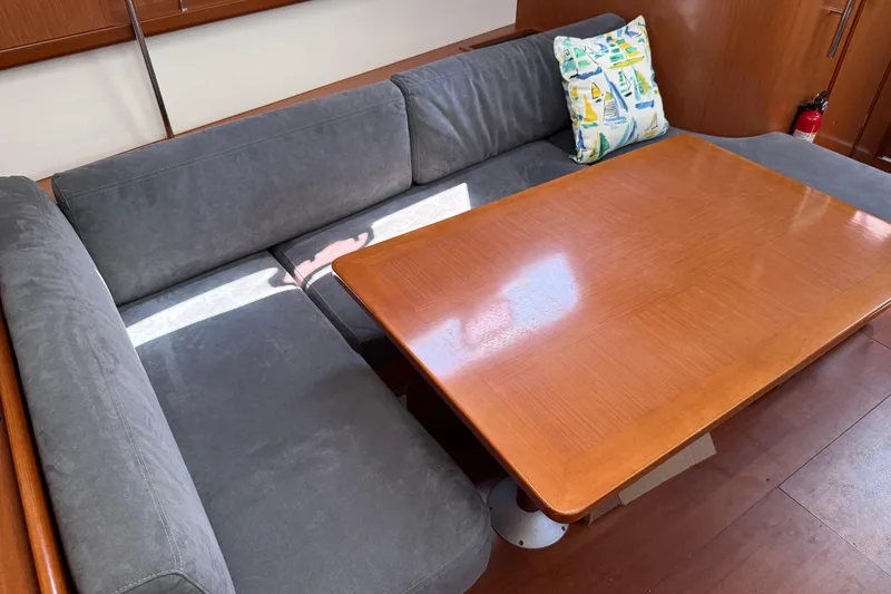 Slide: The Image of Interior of 2010 Beneteau Oceanis 43 yacht with gray seating and wooden table. - 28