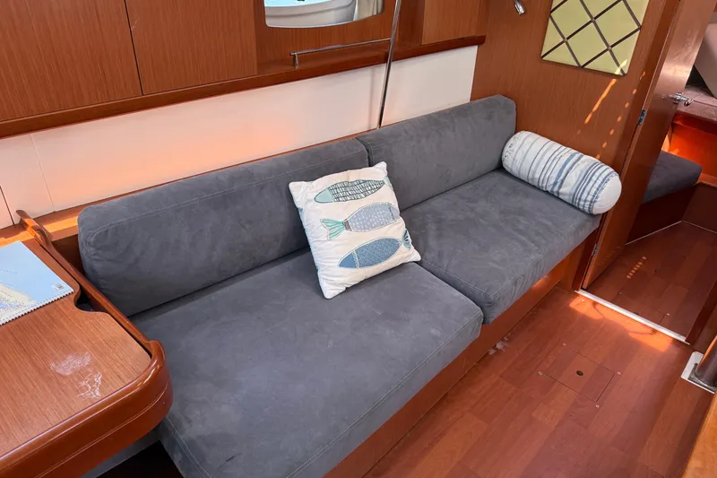 Slide: The Image of Interior of 2010 Beneteau Oceanis 43 yacht with gray sofa and decorative pillows. - 30