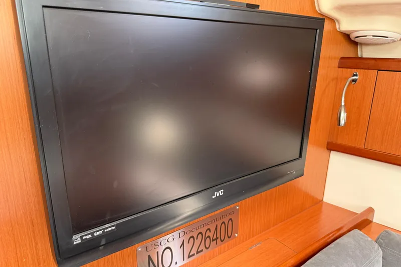 Slide: The Image of JVC TV on 2010 Beneteau Oceanis 43 yacht interior with wooden paneling. - 31