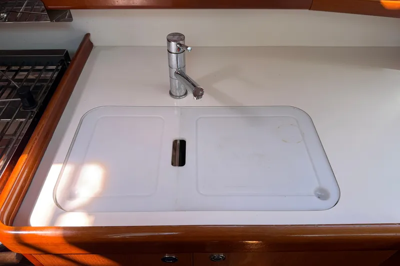 Slide: The Image of Galley sink area on 2010 Beneteau Oceanis 43 sailboat, featuring a sleek faucet. - 43