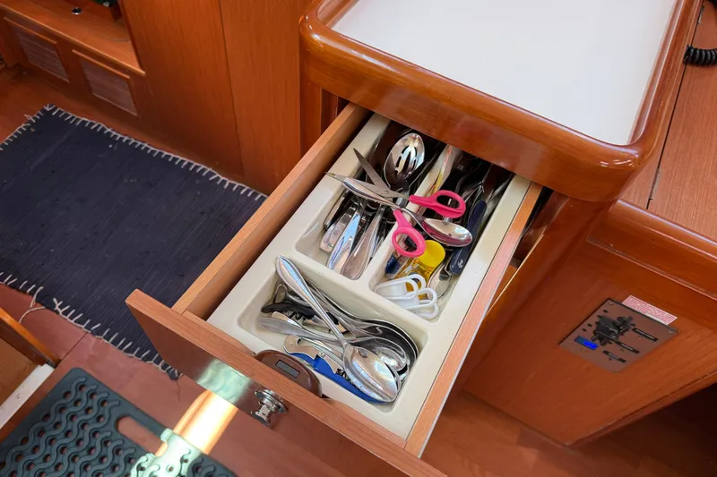 Slide: The Image of Open drawer with utensils and scissors in a 2010 Beneteau Oceanis 43 yacht kitchen. - 45