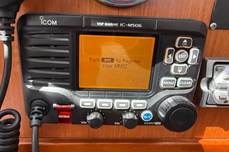 Slide: The Image of VHF marine radio on 2010 Beneteau Oceanis 43 sailboat, displaying MMSI registration prompt. - 49