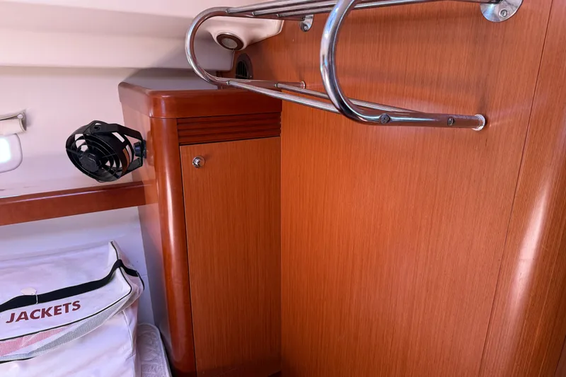 Slide: The Image of Interior of 2010 Beneteau Oceanis 43 yacht with wooden cabinetry and storage area. - 59