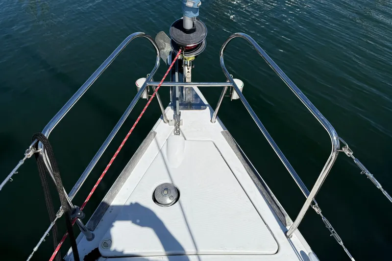 Slide: The Image of Bow of 2010 Beneteau Oceanis 43 sailboat with stainless steel railings and winch. - 6
