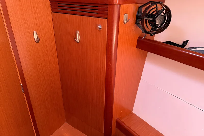 Slide: The Image of Interior of 2010 Beneteau Oceanis 43 yacht with wooden cabinetry and small fan. - 60