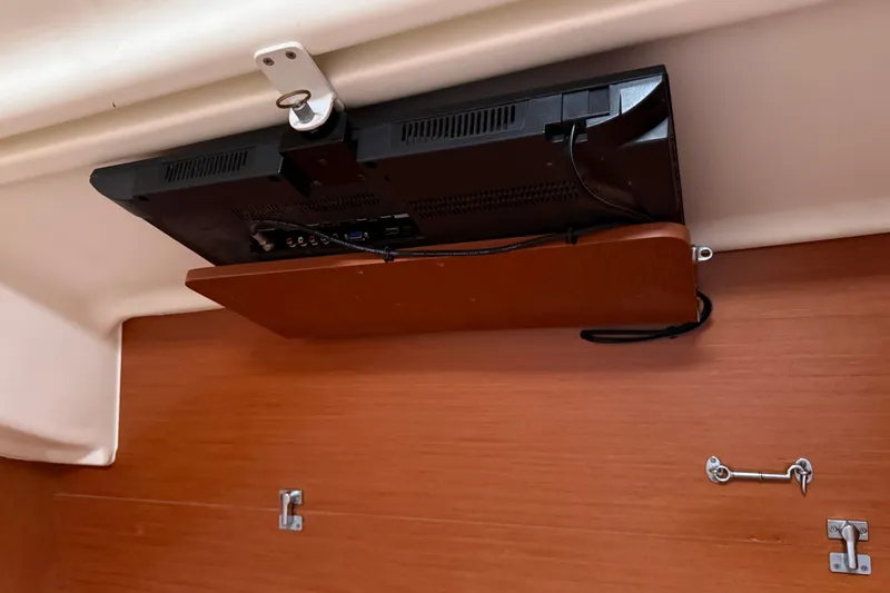 Slide: The Image of TV mounted on a wooden panel inside a 2010 Beneteau Oceanis 43 yacht. - 68
