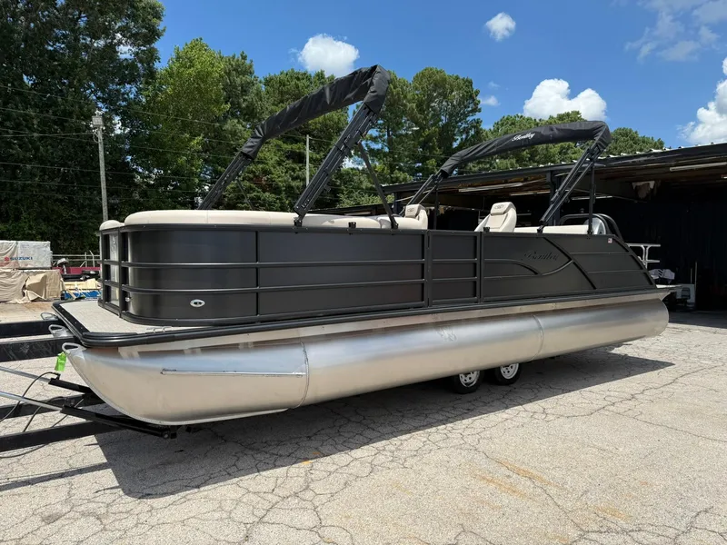 Slide: The Image of 2026 Bentley Pontoons Legacy 243 Swingback on trailer, parked outdoors. - 3