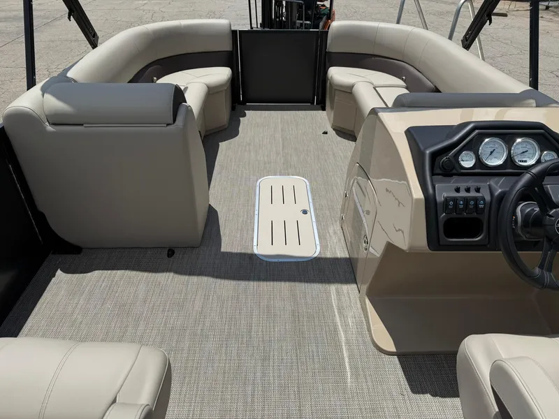 Slide: The Image of 2026 Bentley Pontoons Legacy 243 Swingback interior with beige seating and modern dashboard. - 7
