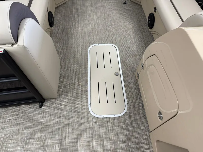 Slide: The Image of Interior of 2026 Bentley Pontoons Legacy 243 Navigator, featuring beige seating and carpeted flooring. - 3
