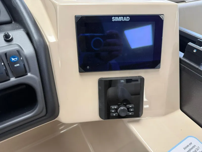 Slide: The Image of 2026 Bentley Pontoons Legacy 243 Navigator dashboard with Simrad display and JBL audio controls. - 7