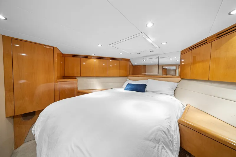 Slide: The Image of Luxurious bedroom interior of 2002 Hatteras 60 Convertible yacht with wood cabinetry. - 20