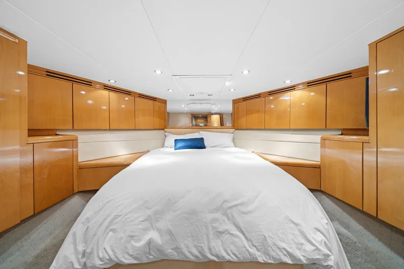 Slide: The Image of Luxurious bedroom interior of 2002 Hatteras 60 Convertible yacht with wood cabinetry. - 22