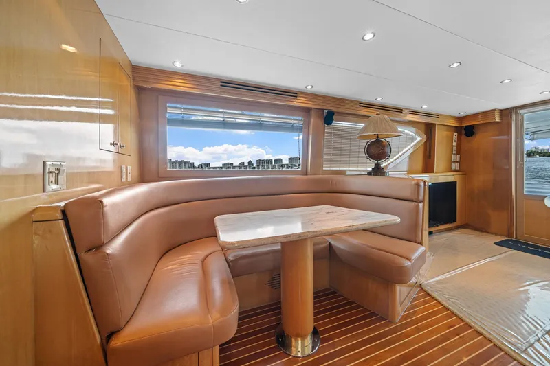 Slide: The Image of Luxurious interior of 2002 Hatteras 60 Convertible yacht with leather seating and wooden finishes. - 26