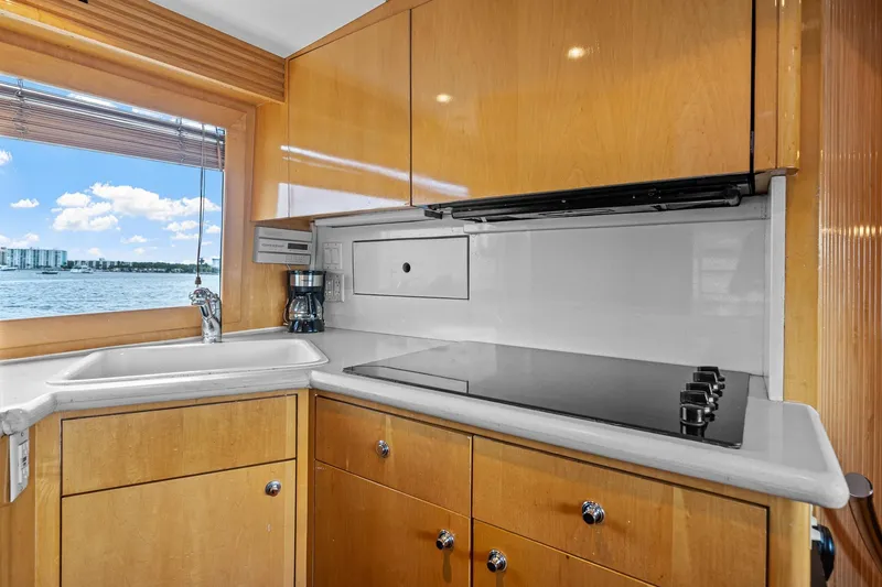 Slide: The Image of Kitchen area of 2002 Hatteras 60 Convertible yacht with ocean view. - 27