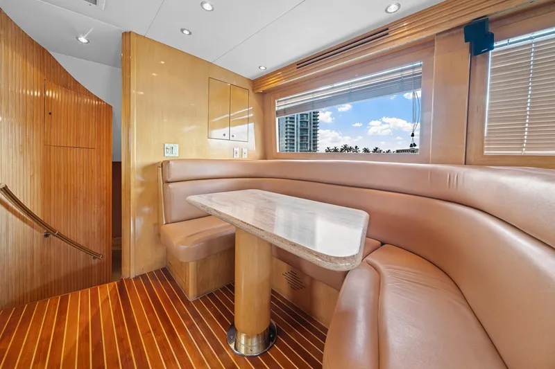 Slide: The Image of Luxurious interior of 2002 Hatteras 60 Convertible yacht with elegant seating and wooden finishes. - 29