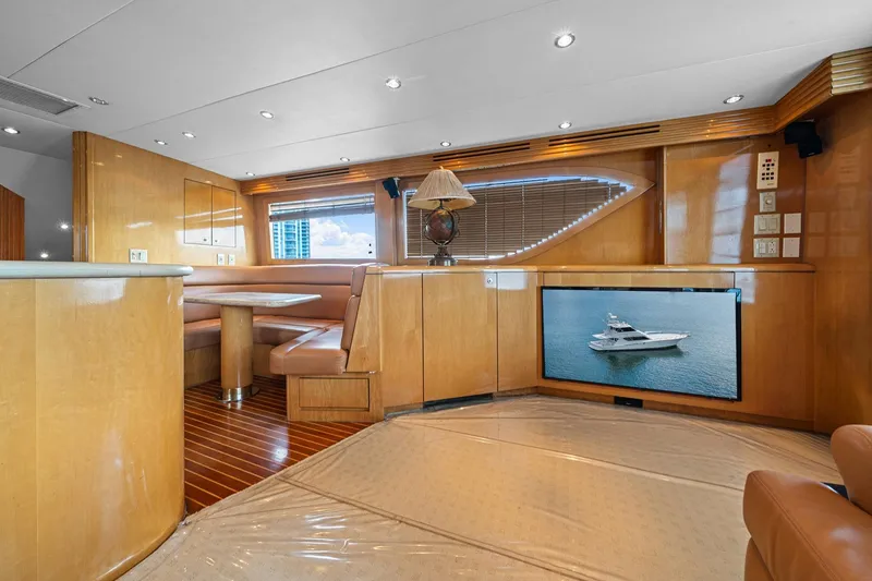 Slide: The Image of Luxurious interior of 2002 Hatteras 60 Convertible yacht with wood finishes and seating area. - 32