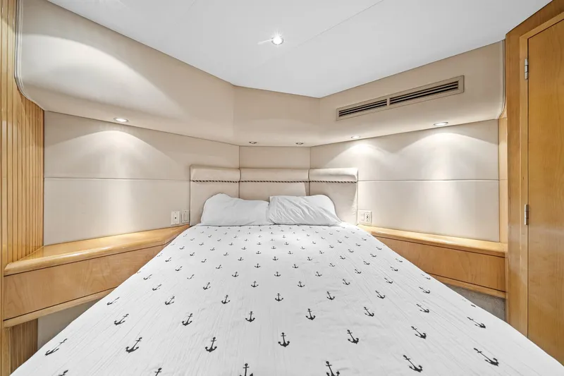 Slide: The Image of Luxurious bedroom interior of 2002 Hatteras 60 Convertible yacht with anchor-patterned bedding. - 36