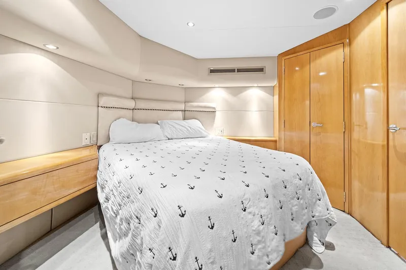 Slide: The Image of Luxurious bedroom interior of 2002 Hatteras 60 Convertible yacht with anchor-patterned bedding. - 37