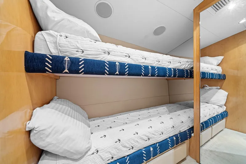 Slide: The Image of Bunk beds in 2002 Hatteras 60 Convertible yacht cabin with nautical-themed bedding. - 38