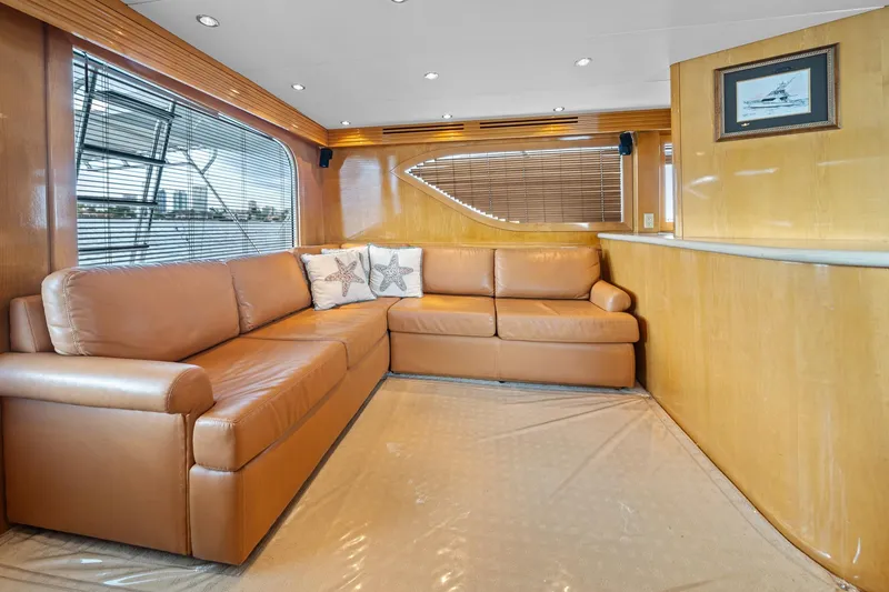 Slide: The Image of Luxurious interior of 2002 Hatteras 60 Convertible yacht with leather seating and wood paneling. - 40