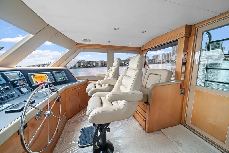 Slide: The Image of Luxurious helm of 2002 Hatteras 60 Convertible yacht with plush seating and modern controls. - 44