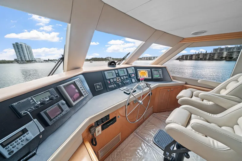 Slide: The Image of Luxurious 2002 Hatteras 60 Convertible yacht helm with modern navigation equipment and plush seating. - 46