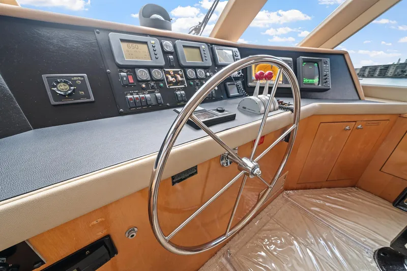 Slide: The Image of Helm of 2002 Hatteras 60 Convertible yacht with steering wheel and navigation instruments. - 47