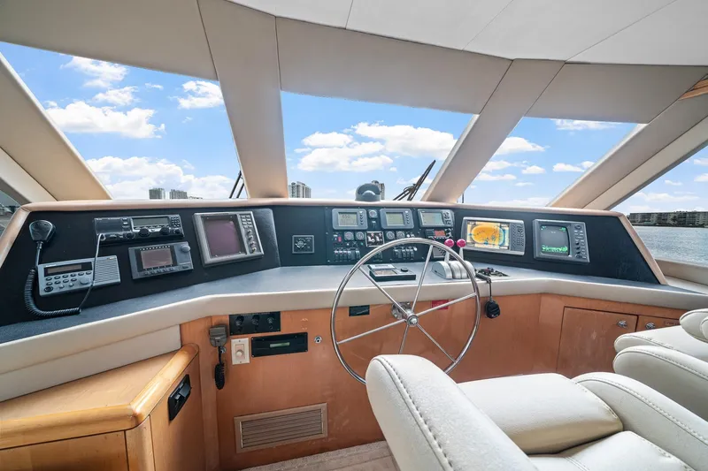 Slide: The Image of Helm of 2002 Hatteras 60 Convertible yacht with navigation equipment and steering wheel. - 48