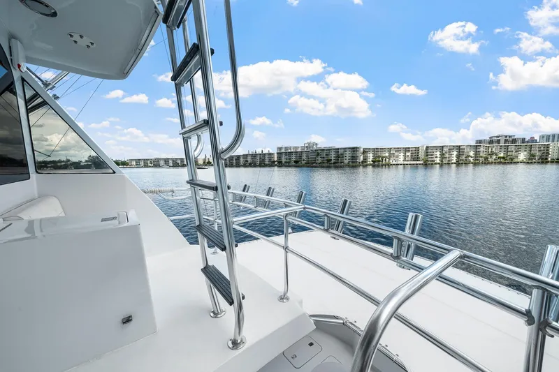 Slide: The Image of 2002 Hatteras 60 Convertible yacht deck with ocean view and clear blue sky. - 55