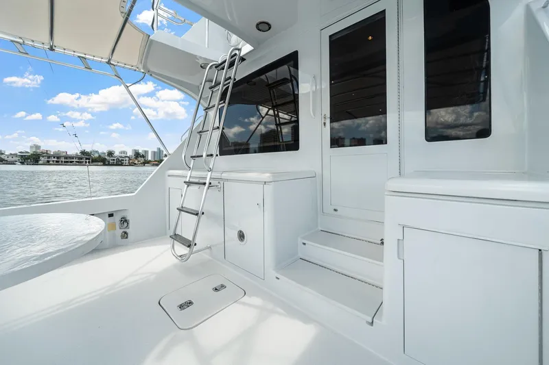 Slide: The Image of 2002 Hatteras 60 Convertible yacht deck with ladder and storage compartments. - 57