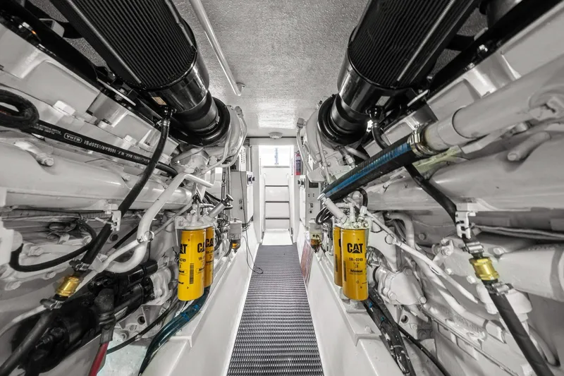 Slide: The Image of Engine room of 2002 Hatteras 60 Convertible yacht, featuring dual Caterpillar engines. - 69