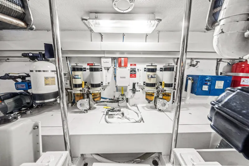 Slide: The Image of Engine room of 2002 Hatteras 60 Convertible yacht, featuring fuel filters and equipment. - 70